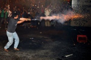 From the AFP. An Indonesian student launches fireworks towards police during a protest against the fuel price hike outside parliament in Jakarta on June 17, 2013.